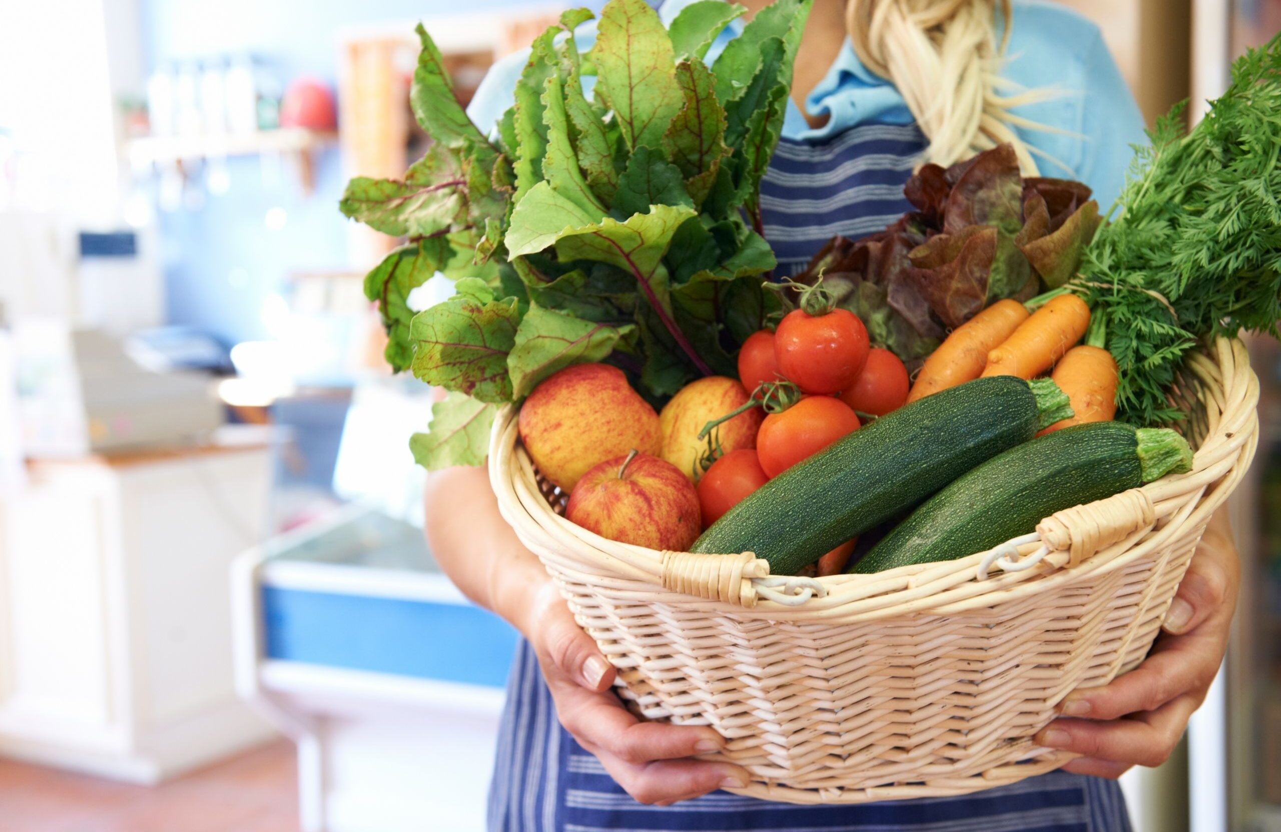 basket of organic produce in a tan basket for delivery