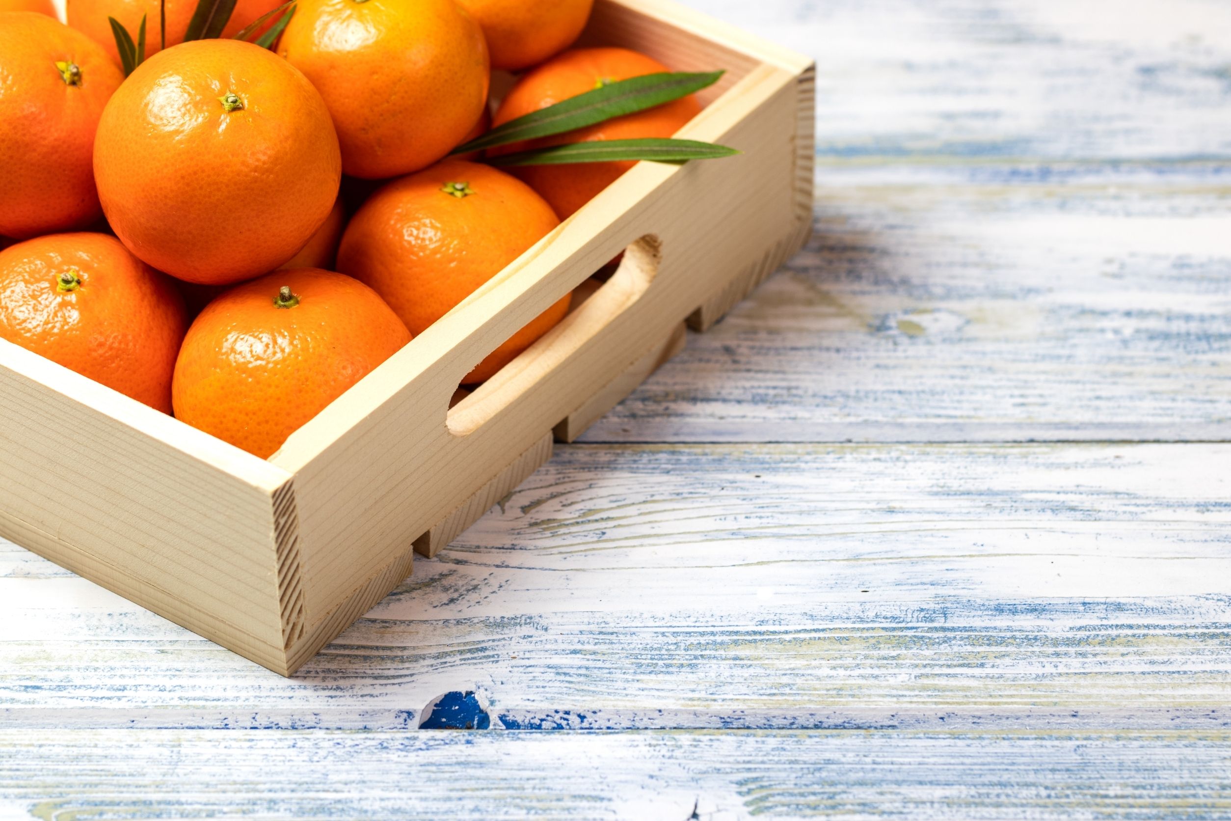 affordable oranges for sale online seen in a wood crate