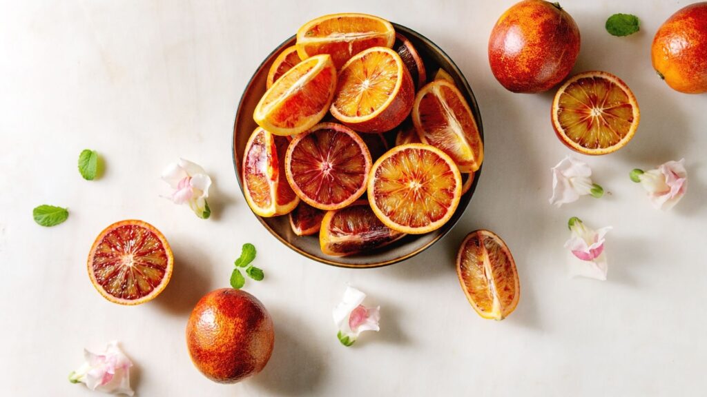 a bowl of cut up blood oranges sitting on a table
