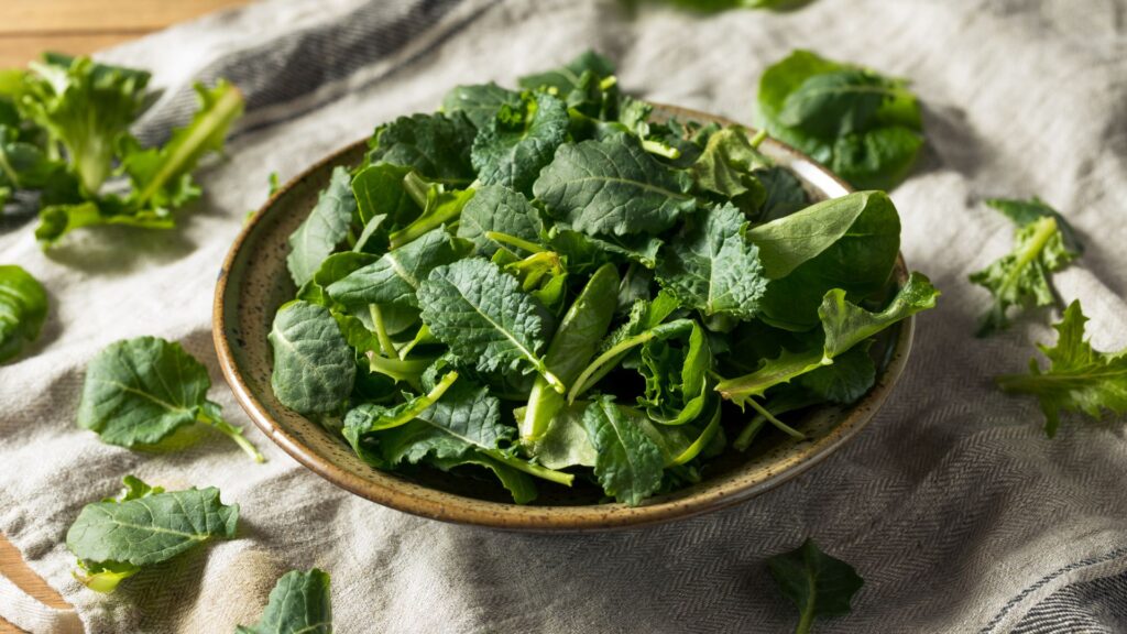 fresh baby kale rests in a bowl on display